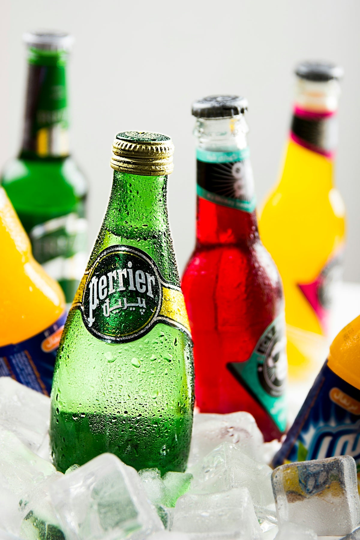 several Perrier glass drink bottles