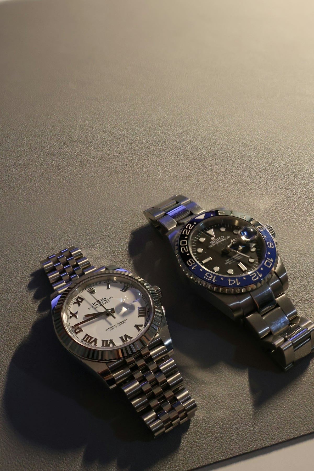 A couple of watches sitting on top of a table