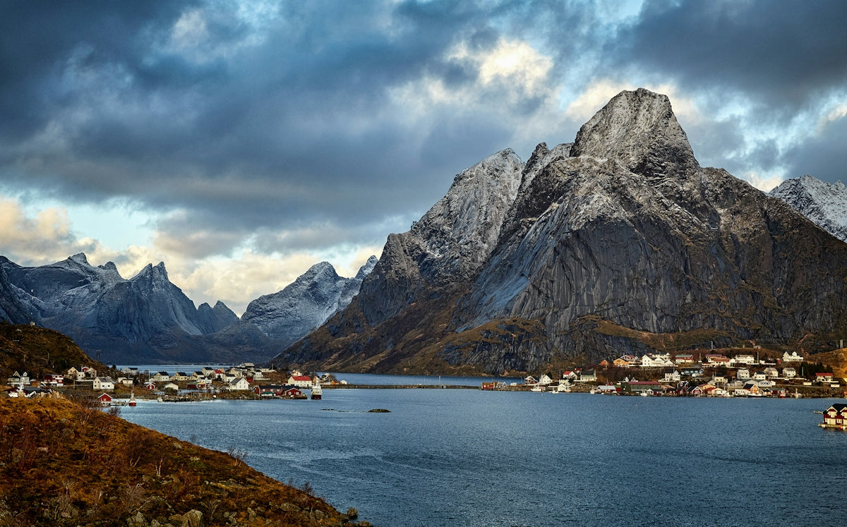 A village with red houses on the coast of Reine in Lofoten, Norway