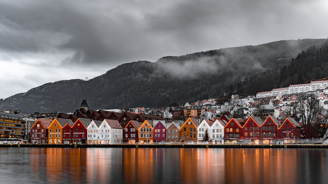 Colorful wooden houses along the Bryggen wharf in Bergen under a cloudy sky