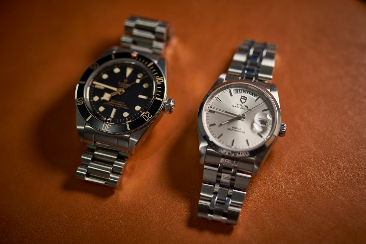 a couple of watches sitting on top of a table