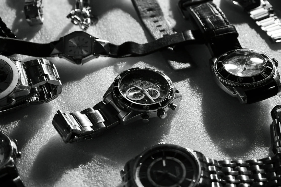 A bunch of watches that are laying on a table