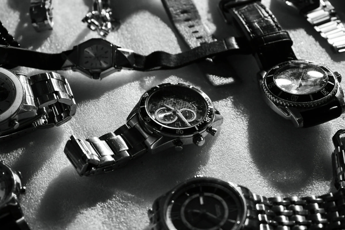 A bunch of watches that are laying on a table